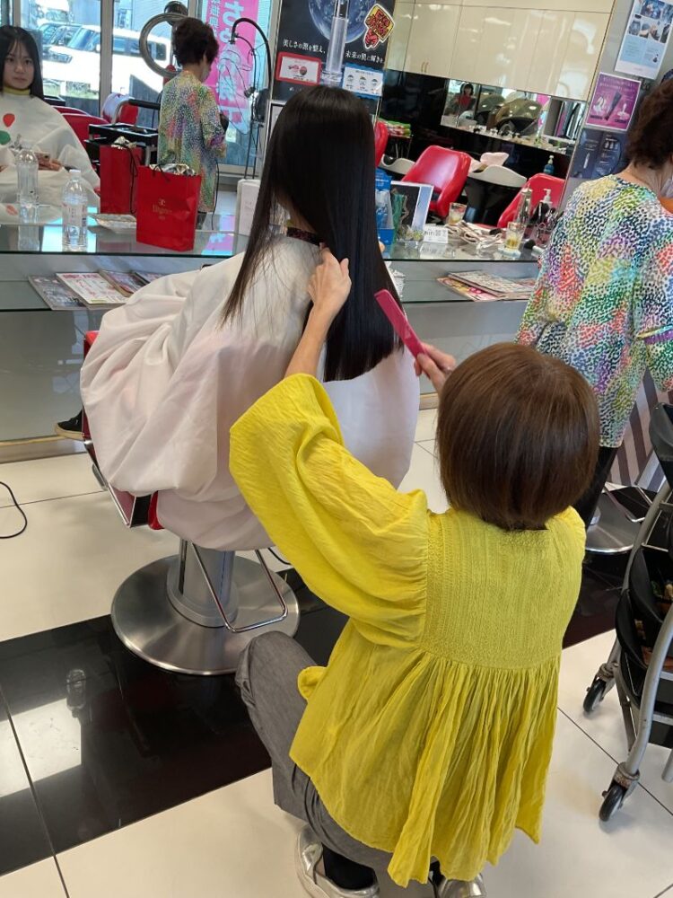 ストレートヘアをカットするスタイリスト