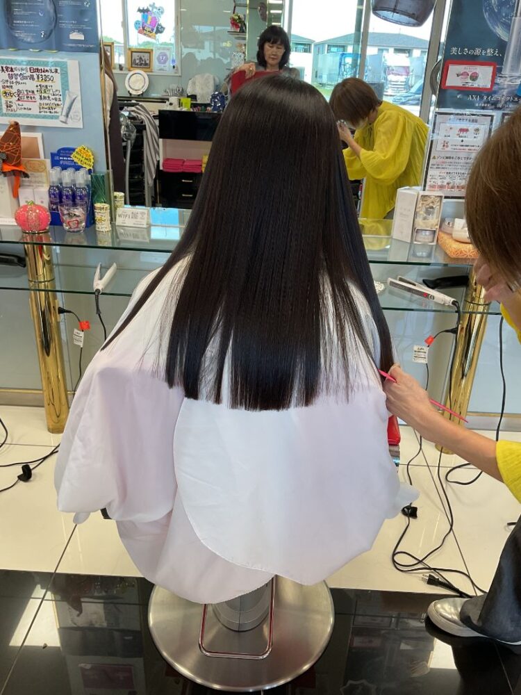 ストレートヘアをカットするスタイリスト